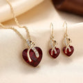 Conjunto de joyas de corazón trenzado de oro y rubí